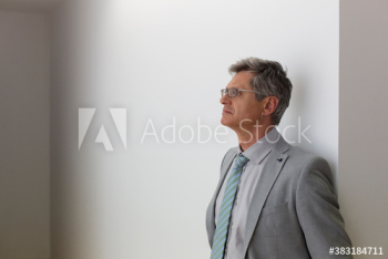 Thoughtful mature corporate businessman looking away Thoughtful mature corporate businessman looking away
