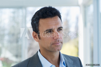 Thoughtful serious businessman looking away