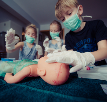 Three Children Playing Operation Toy Three Children Playing Operation Toy