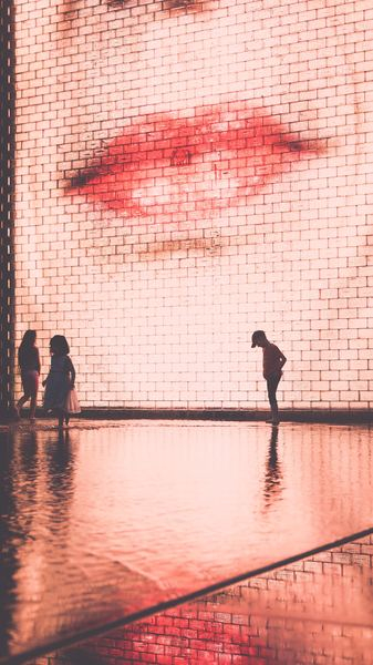 three children standing in front of the wall three children standing in front of the wall