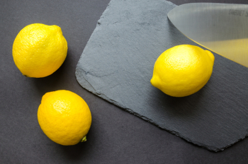 Three Lemons on Grey Surface Three Lemons on Grey Surface