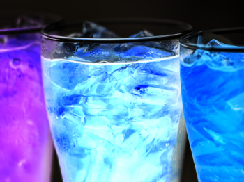 Three Lighted Cocktails Inside Drinking Glasses Three Lighted Cocktails Inside Drinking Glasses