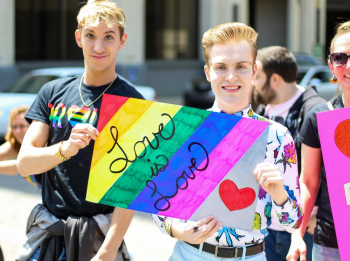 Three Men Holding Assorted Painted Love Is Love Banner Three Men Holding Assorted Painted Love Is Love Banner