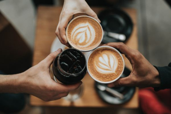 three person holding beverage cups three person holding beverage cups