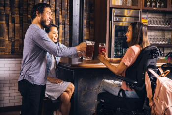 Three Smiling People Toasting Their Drinks Three Smiling People Toasting Their Drinks