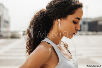Tired sportswoman taking a break after workout Tired sportswoman taking a break after workout