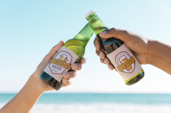 Toasting with two beet bottles at the beach Free Psd