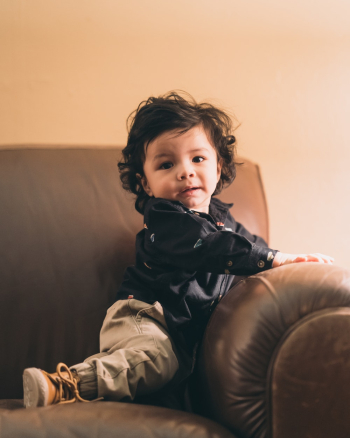 Toddler on Brown Sofa Toddler on Brown Sofa