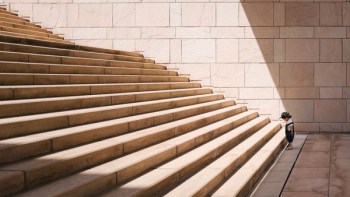 toddler's standing in front of beige concrete stair toddler's standing in front of beige concrete stair