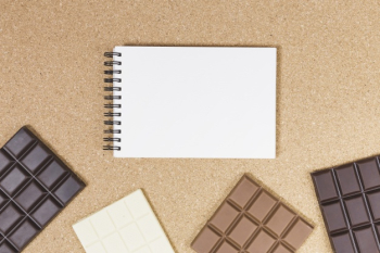 Top view chocolate bars with notebook Free Photo