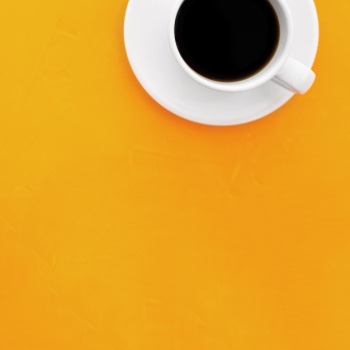 Top view image of coffee cup on wooden yellow background Top view image of coffee cup on wooden yellow background