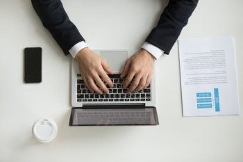 Top view of company ceo typing at laptop Top view of company ceo typing at laptop