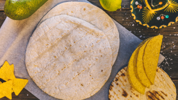 Top view of mexican tortilla and tasty nachos on wooden table