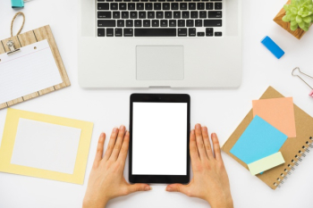 Top view of office desk with tablet mockup Free Photo