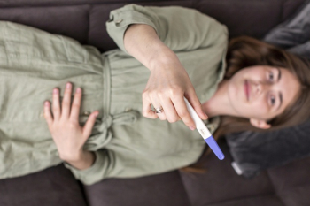 Top view woman holding pregnancy test Free Photo