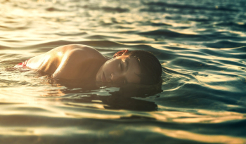 Topless Man in Body of Water Topless Man in Body of Water