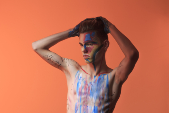 Topless Man Posing With Blue and Red Paint on His Body Topless Man Posing With Blue and Red Paint on His Body