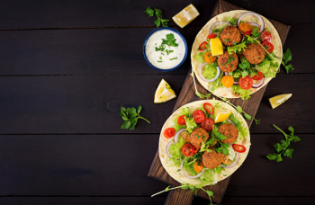 Tortilla wrap with falafel and fresh salad. vegan tacos. vegetarian healthy food. top view Free Photo