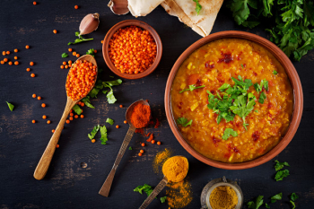 Traditional indian soup lentils. indian dhal spicy curry in bowl, spices, herbs, rustic black wooden table Free Photo