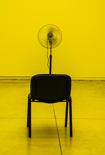 Turned-on Black Pedestal Fan Facing Empty Chair Turned-on Black Pedestal Fan Facing Empty Chair