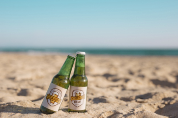 Two beer bottles mockup at the beach Free Psd