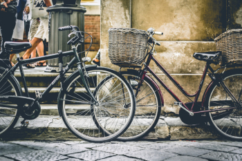 Two Black Bicycles Parting Near Wall Two Black Bicycles Parting Near Wall