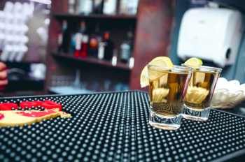 Two Clear Shot Glasses Filled With Alcohol