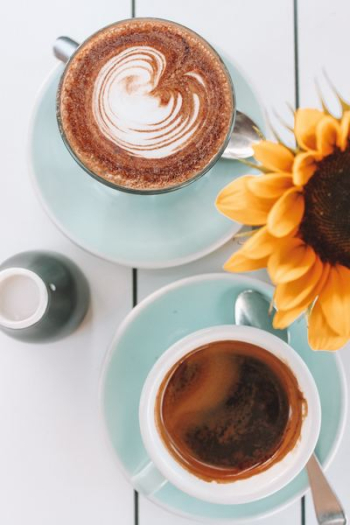 two cups filled with coffee two cups filled with coffee