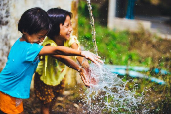 two girl playing water two girl playing water