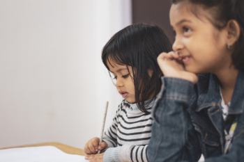 Two Girls Writing on Paper Two Girls Writing on Paper