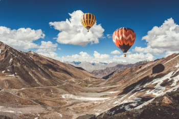 two hot air balloons floating two hot air balloons floating