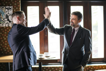 Two Men Standing While Doing High Five Two Men Standing While Doing High Five
