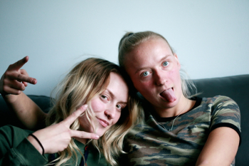 Two People Sitting On Couch Two People Sitting On Couch