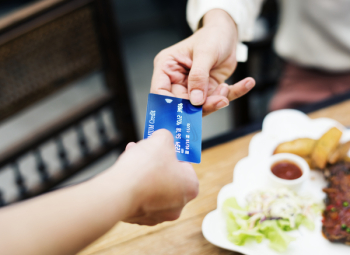 Two Person Holding Credit Card Closeup Photo