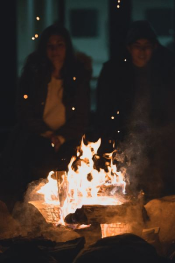 two person infront bondfire two person infront bondfire