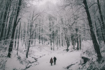two person walking on snow two person walking on snow