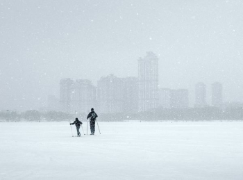 two persons walking on snow two persons walking on snow
