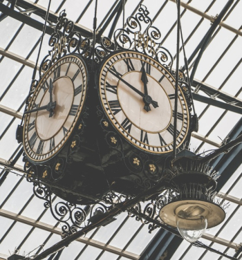 Two Round Brown Wooden Analog Clocks Two Round Brown Wooden Analog Clocks