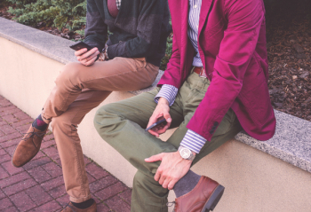 Two sitting men with phones Two sitting men with phones
