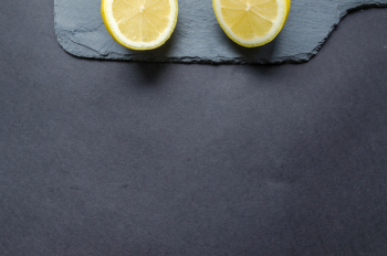 Two Sliced Lemons on Black Surface Two Sliced Lemons on Black Surface