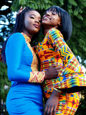 Two Smiling Women Standing Side By Side Two Smiling Women Standing Side By Side