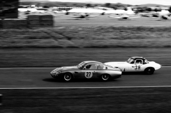 two vintage race cars racing