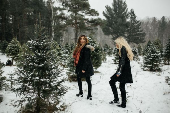 two woman walking towards snow two woman walking towards snow