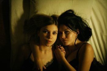 Two Women Laying On Bed
