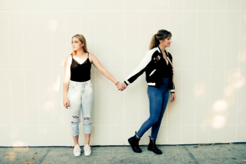 Two Women Standing Against Wall Two Women Standing Against Wall