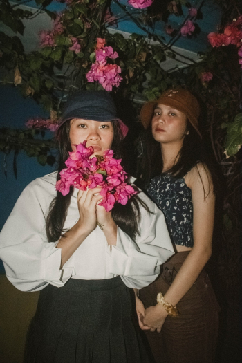 Two Women Standing Near Pink Bougainvillea Flowers Two Women Standing Near Pink Bougainvillea Flowers