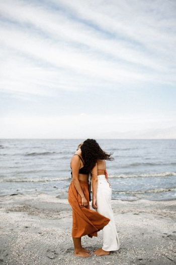 two women standing on beach