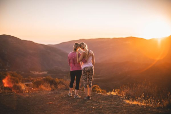 two women standing on moutain two women standing on moutain