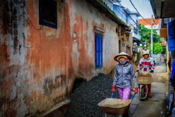 two women walking beside orange house two women walking beside orange house