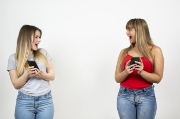 Two young females looking at each other Free Photo